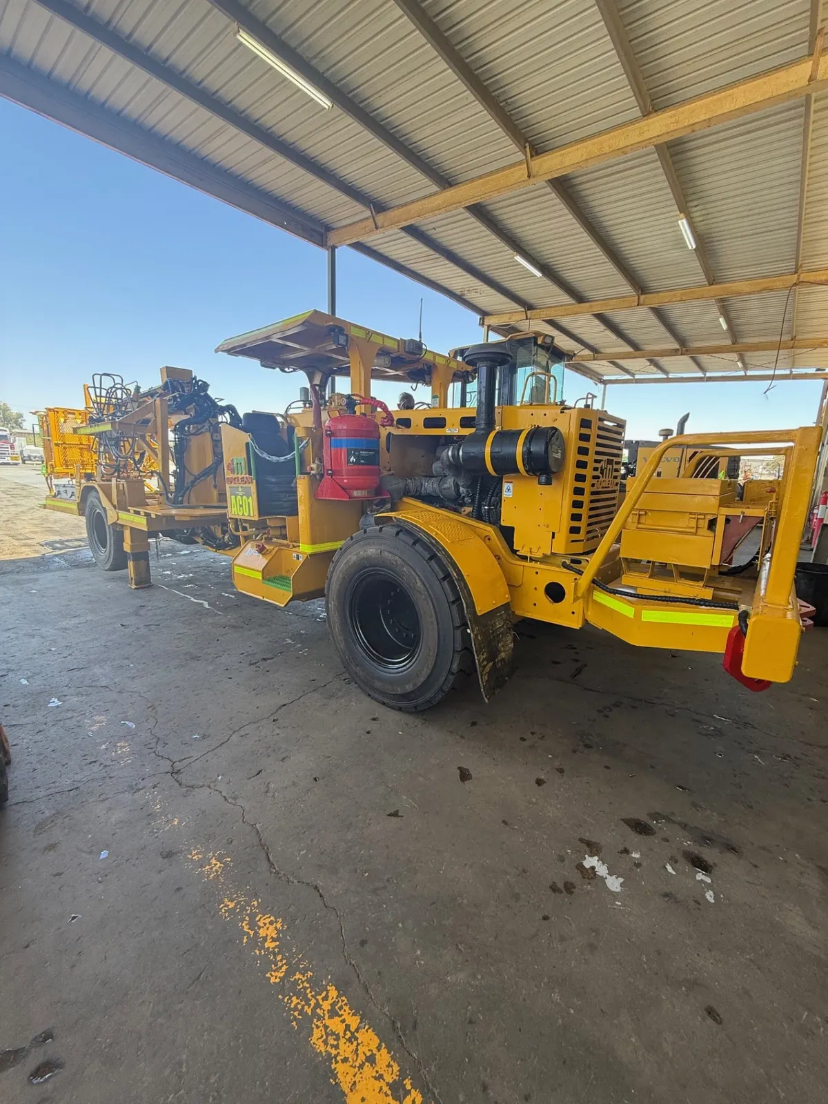 Underground mining drill rig parked in the HES workshop bay for repairs
