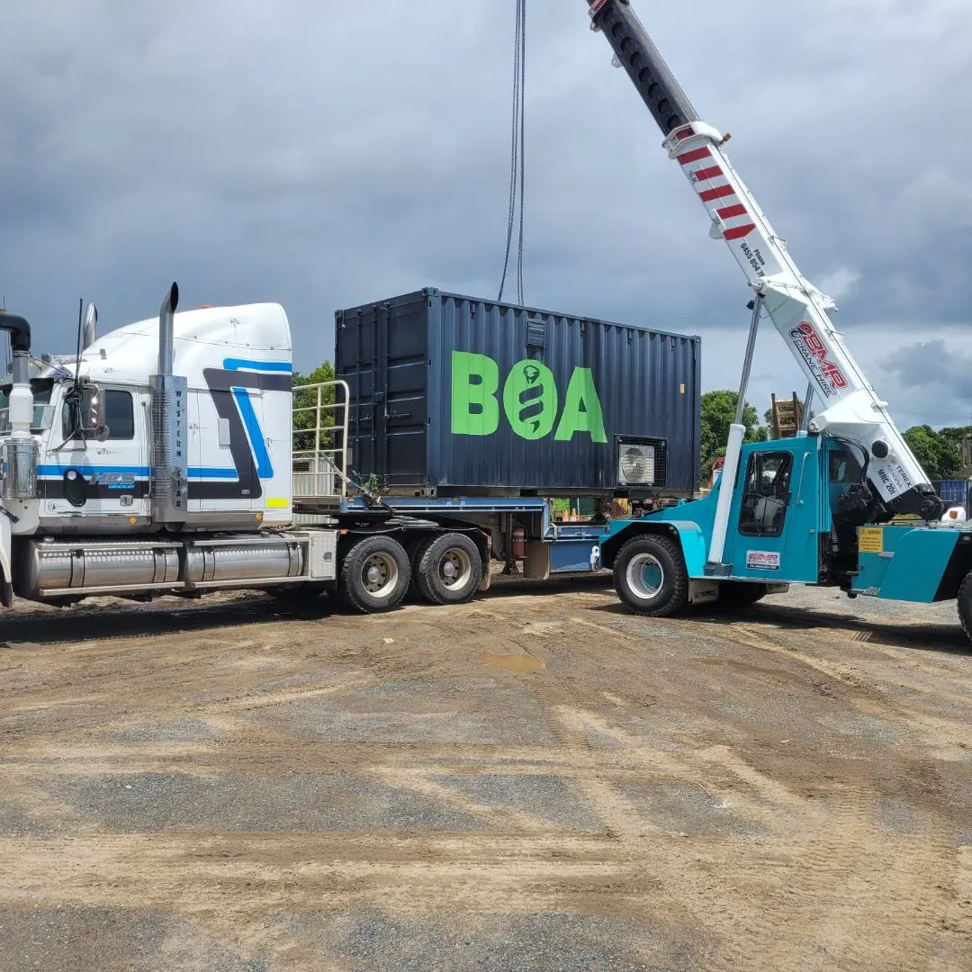 BOA container being lifted onto an HES truck by a mobile crane